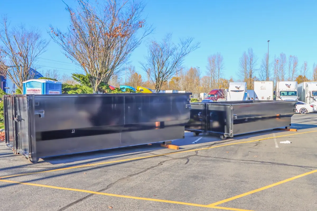 Professional dumpster rental service with roll-off container on residential driveway in Haverford